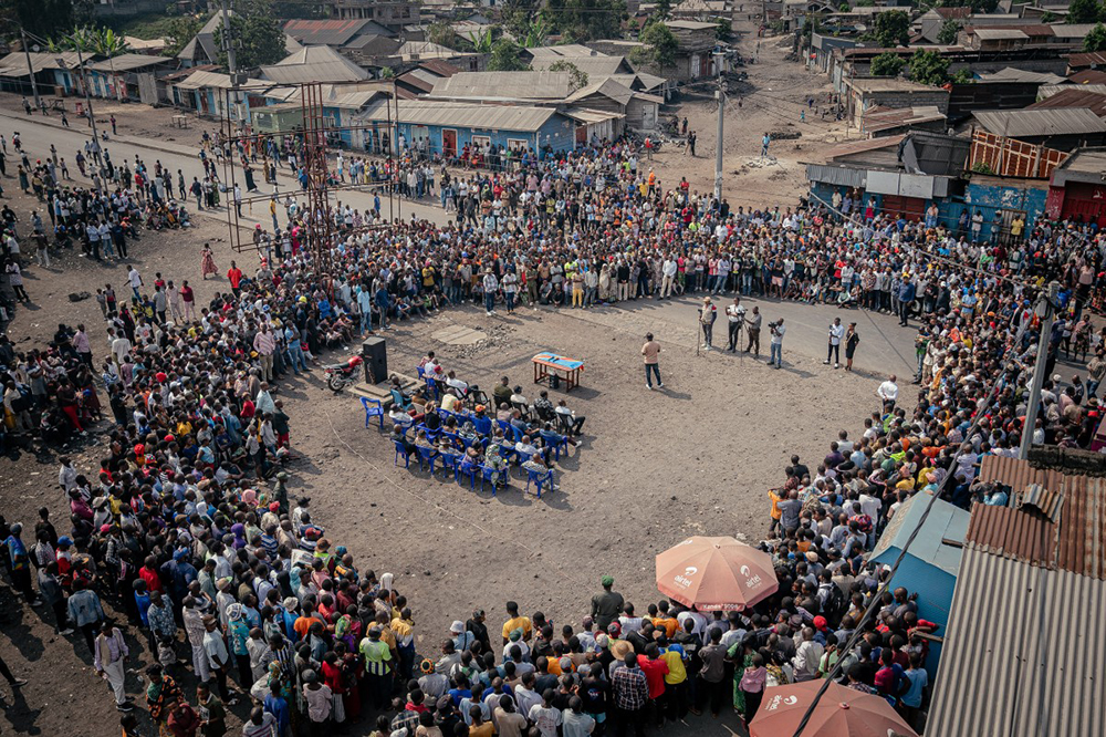This aerial view shows the gathering site of the AFC/M23 meeting in Goma on July 24, 2025. The gathering is part of an outreach strategy aimed at building trust with the local population. (Photo by Jospin Mwisha / AFP)
