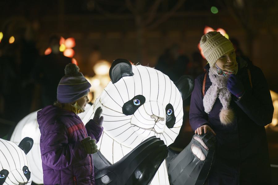 People visit a lantern display celebrating the upcoming Chinese Lunar New Year at the John F. Kennedy Center for the Performing Arts in Washington D.C., the United States, January. 29, 2022. AFP Photo