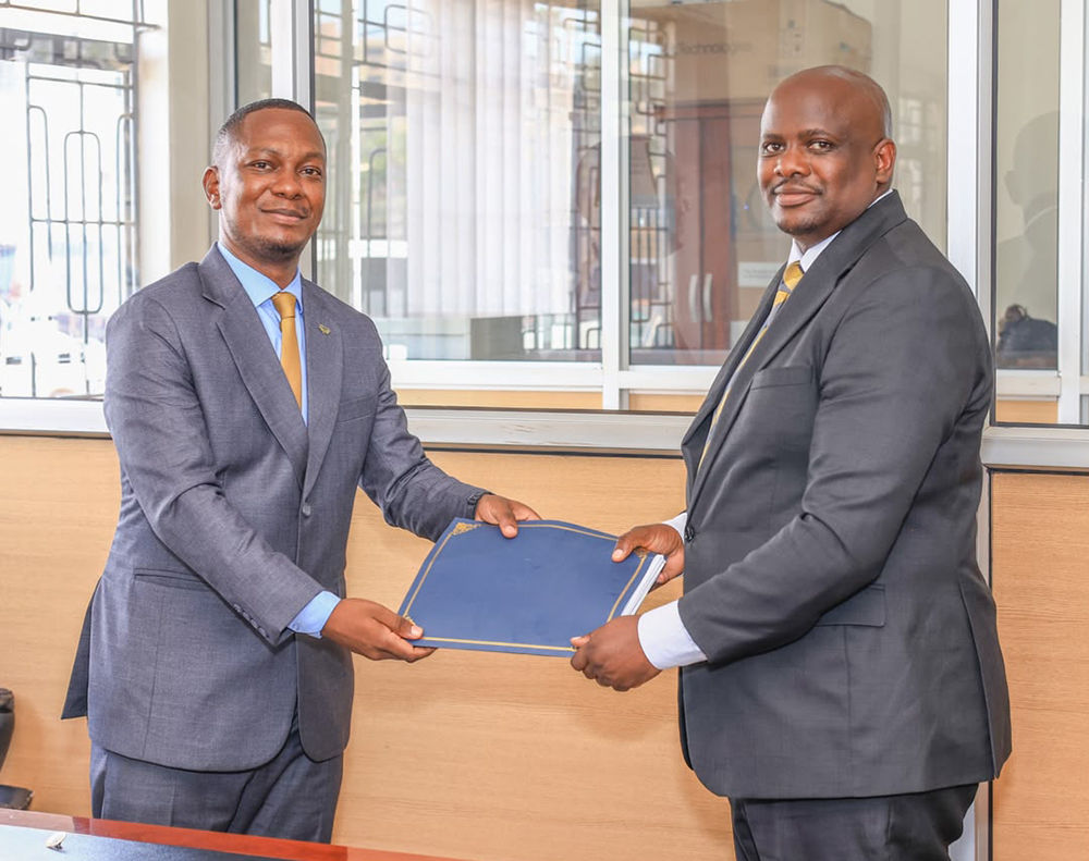 Allan Ssempebwa hands over the senior communications office to Emmanuel Ainebyoona. (Courtesy photo)
