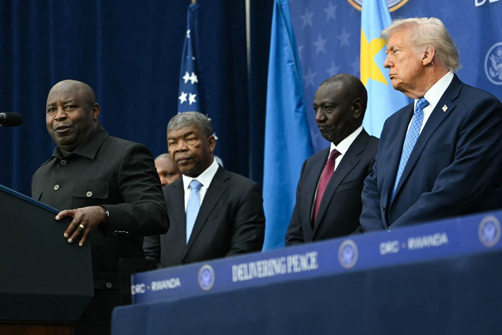 (L/R) Burundi's President Evariste Ndayishimiye speaks as Angola's President Joao Lourenco, Kenya's President William Ruto, and US President Donald Trump look on during a signing ceremony hosted by Trump for a peace deal between Rwanda and the Democratic Republic of the Congo at the United States Institute of Peace in Washington, DC, on December 4, 2025. (Credit: AFP)