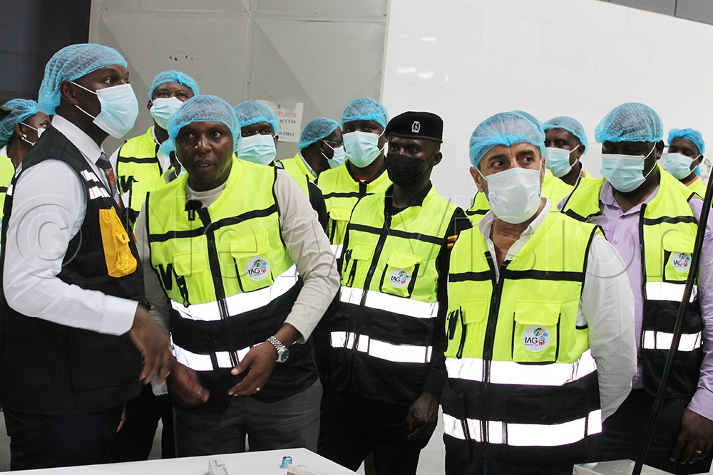 Nelson Tugume (2nd left), Chief Executive Officer of Inspire Africa Coffee Park, together with members of his team, briefs State Minister Jonard Asiimwe Akiiki (Left) and other guests on the products manufactured at the facility. (Photo by Abdulkarim Ssengendo)