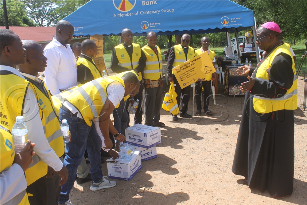   Bishop Francis Aquirinus Kibira of the Kasese Catholic Diocese blessing donated items from MTN Uganda. 
