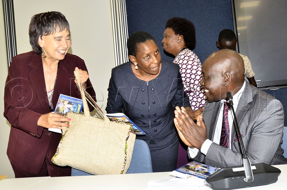 The fundraising brand face of National Forum of People with HIV/AIDS Network in Uganda (NAFOPHANU) home, Prof Dr. Maggie Kigozi (left) chat with the chairperson of the Parliamentary Committee on HIV/AIDS, and MP for Bugiri Municipality, John Bosco Oketho (right) during the launch of National Forum of People with HIV/AIDS Network in Uganda (NAFOPHANU) strategic plan and fundraising drive for the construction their home at Mbuya Kampala on 23 Sept 2026. Center is the Executive director of NOFUPHANU, Jane Mwiribi. (Credit: Ronnie Kijjambu)