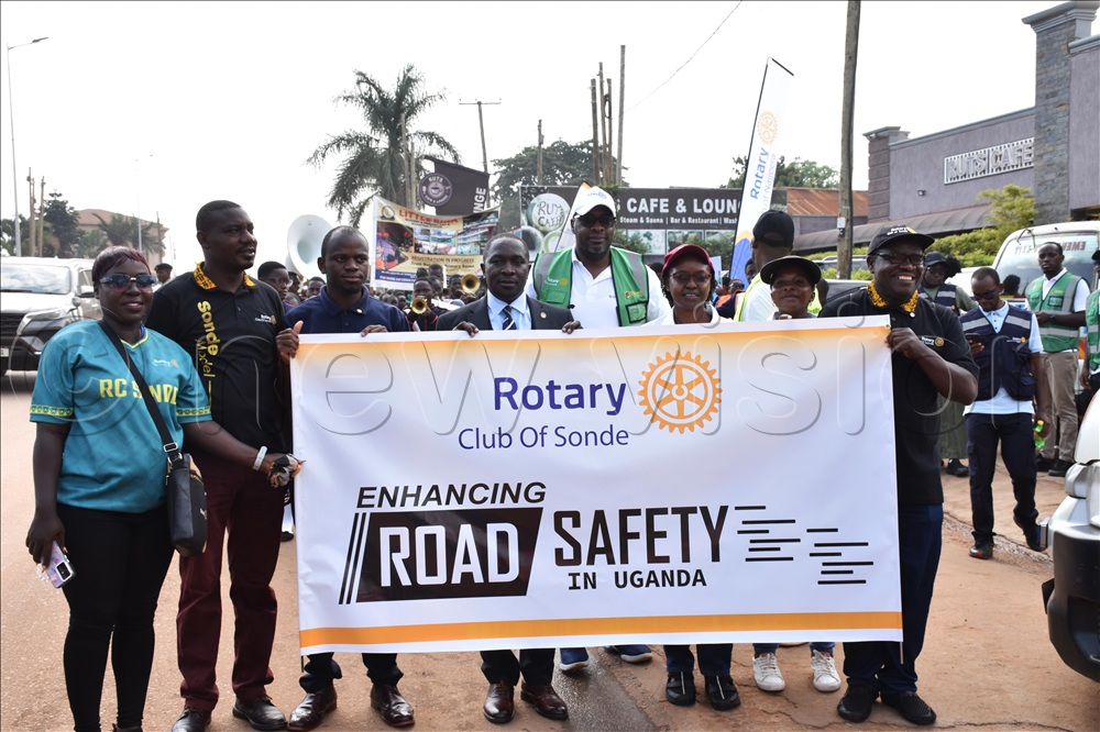 Rotarians from the rotary club of Sonde posing for a photo moment with their banner. This was during the rotary road safety awareness campaign in Kyaliwajjala.