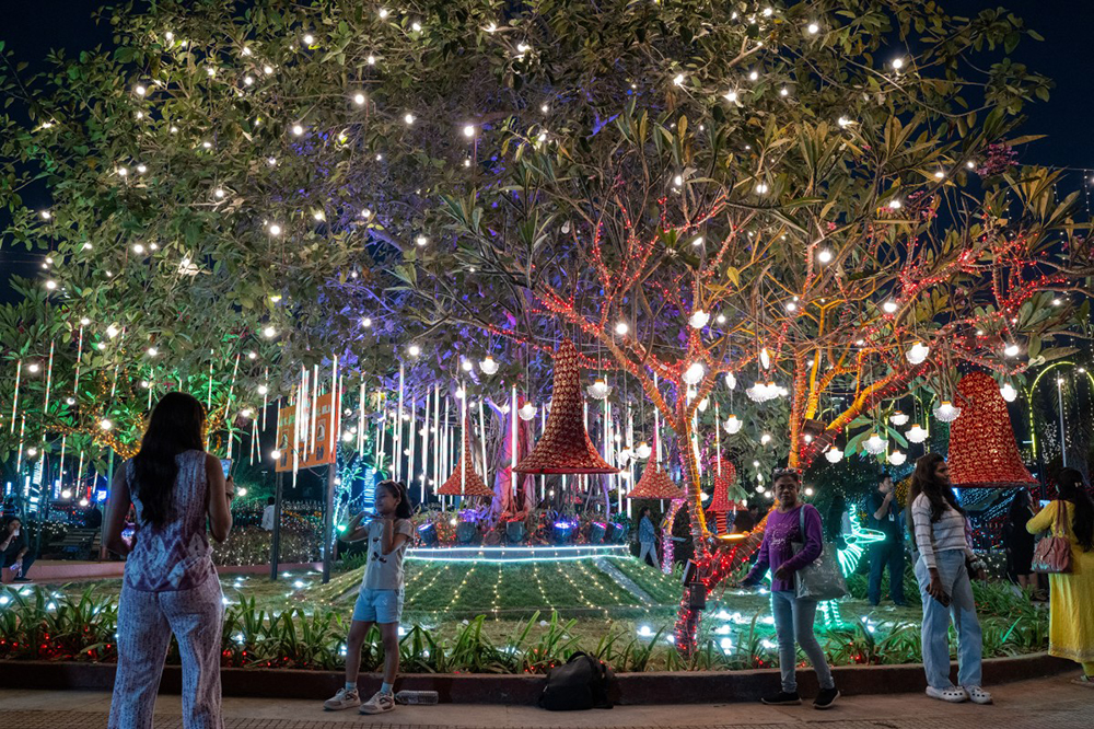 Revellers pose for photographs at an illuminated sea promenade during New Year's Eve in Mumbai on December 31, 2025. (AFP)