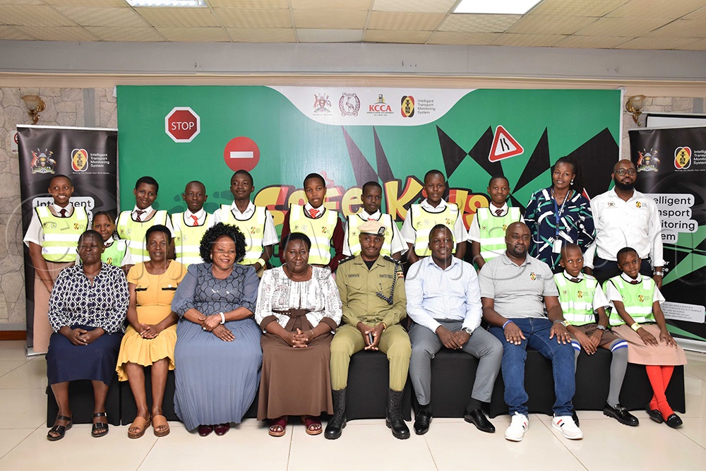 Various stake holders from Intelligent Transport Monitoring System (ITMS), Kampala Capital City Authority (KCCA), Uganda Police, school representative, school going children among key stakeholders at Hotel Africana posing for a photo moment during the closure of the safe Kids, safe future project phase one. (Photo by Simon Peter Tumwine)