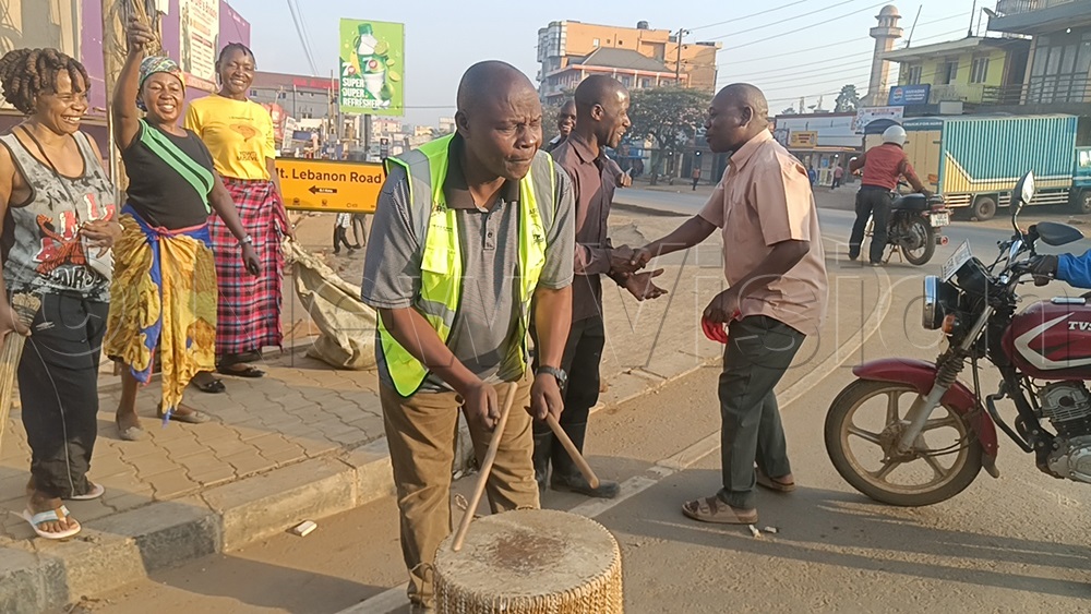 Bishop Dr Samuel Lwandasa, chairperson of the Greater Mukono Interfaith Forum, beats a drum to rally residents to take part in the National Cleaning Day exercise. (Photo by Eric Yiga)