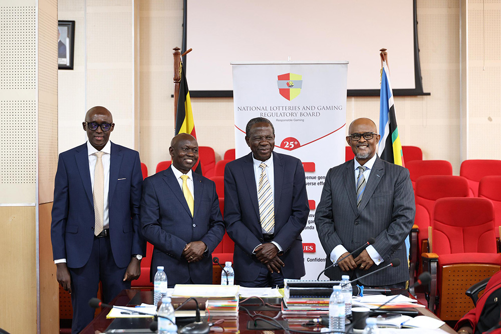 Finance Minister Matia Kasaija, (2R) posing for a picture with the outgoing chairperson Aloysius Mugasa Adyeri and incoming chairperson for the National Lotteries and Gaming Regulatory Board (NLGRB). (Credit: NLGRB)