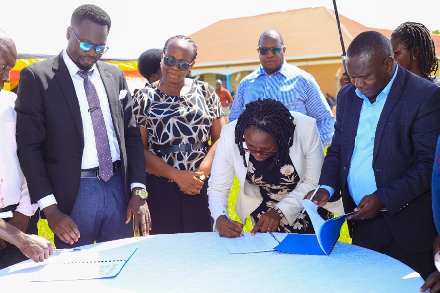 The Hunger Project Country Director and staff sign the handover MOU with Nwoya District officials. (Courtesy)