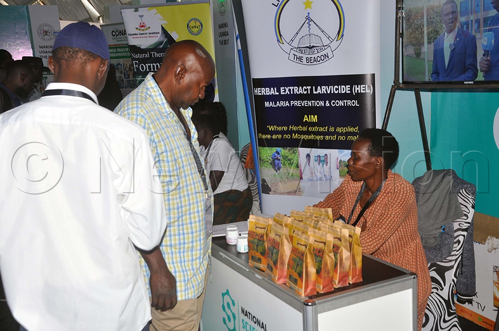 Abonyo (Right) talking to clients during National Science Week 2026, at Kololo Independence Grounds in Kampala. (Photo by John Odyek)