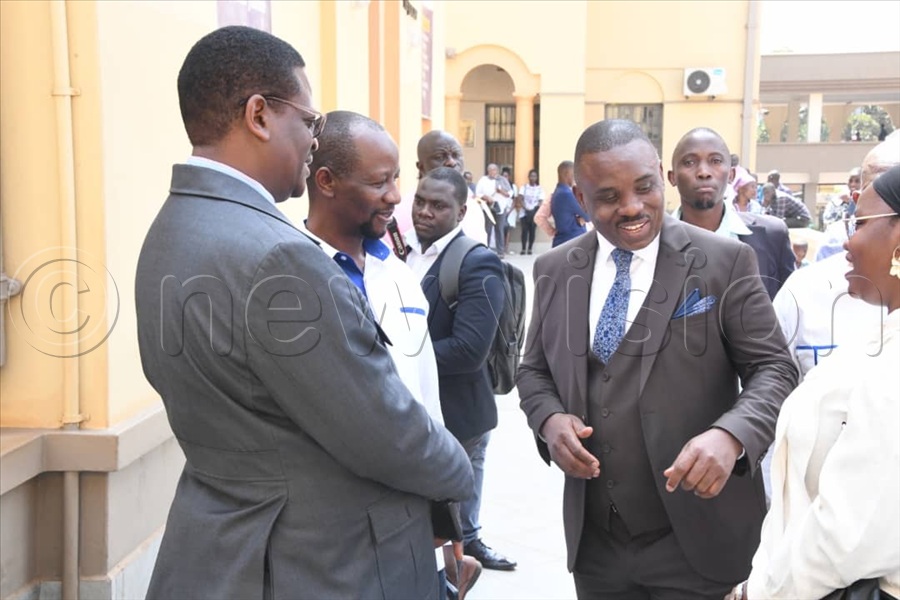Besigye's lawyer Erias Lukwago interacts with MP Ssemujju Nganda and other People’s Front for Freedom (PFF) officials before court proceedings.