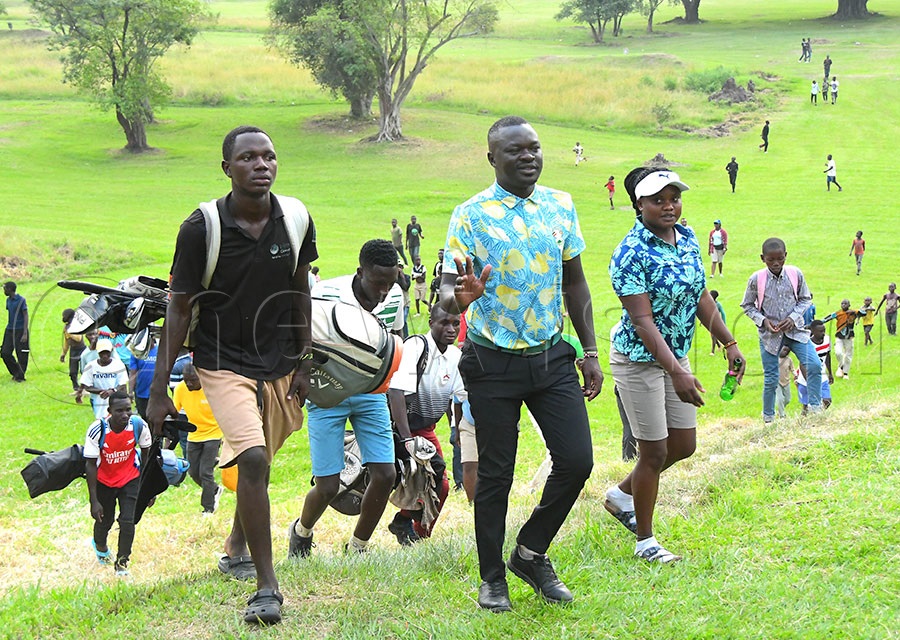 Joseph Cwinyaai (foreground) walks off the course after edging Mackinnon Masereka in a dramatic playoff at the Kilembe Open, held July 26 at Kilembe. Photo by Silvano Kibuuka