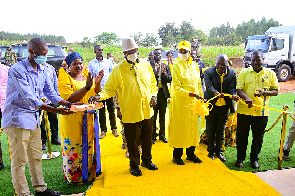  President Museveni accompanied by First Lady Maama Janet Museveni cuts the tape as he opens Mayuge district NRM office in Mayuge town on Wednesday.