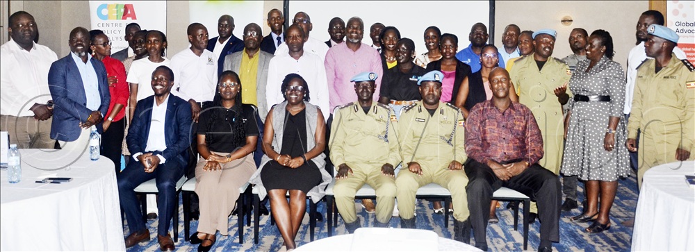  ACP Richard Okullu (in police uniform), 2nd in command of the Marine Unit and the Drowning Prevention Programme Coordinator, Marine Unit Bashiri Siriba, during a consultative meeting with participants at the Four Points by Sheraton in Kampala recently. 