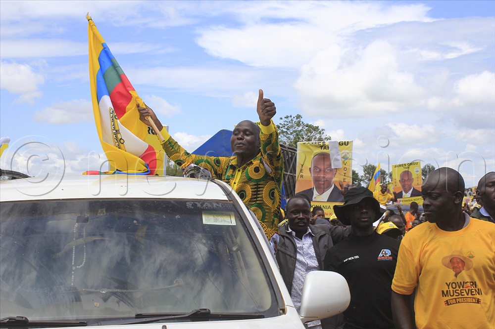 Tony Eron, Kwania County NRM flag-bearer woos his supporters as he arrives at Kwanai Boma Ground on Wednesday. 