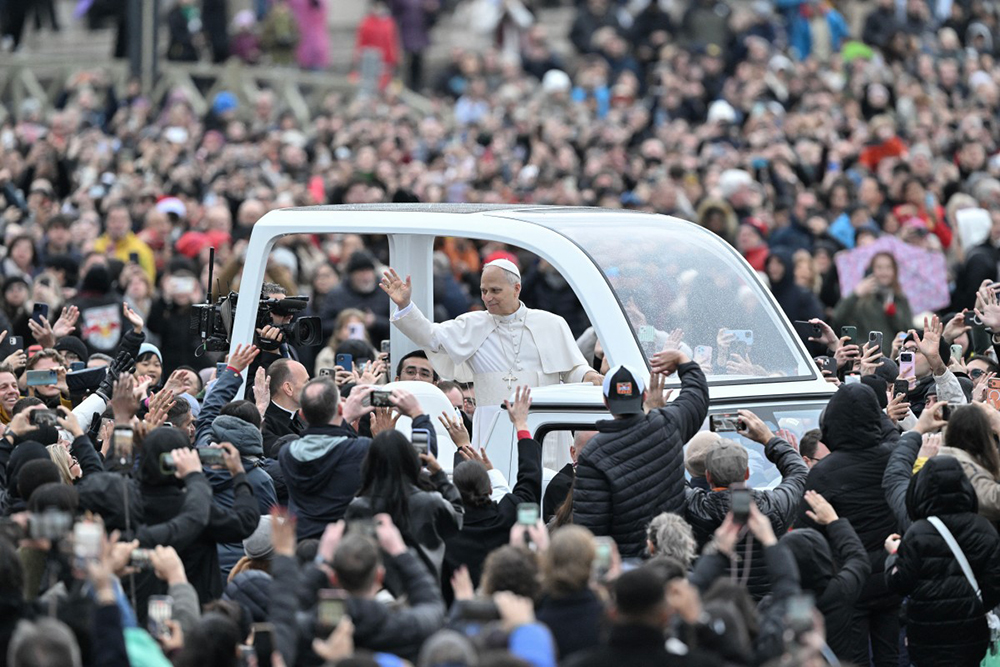 Pope Leo XIV waves to faithfull as he arrives aboard the popemobile ahead of addressing the Urbi et Orbi message and blessing to the city and the world as part of Christmas celebrations, at St Peter's square in the Vatican on December 25, 2025. (AFP)