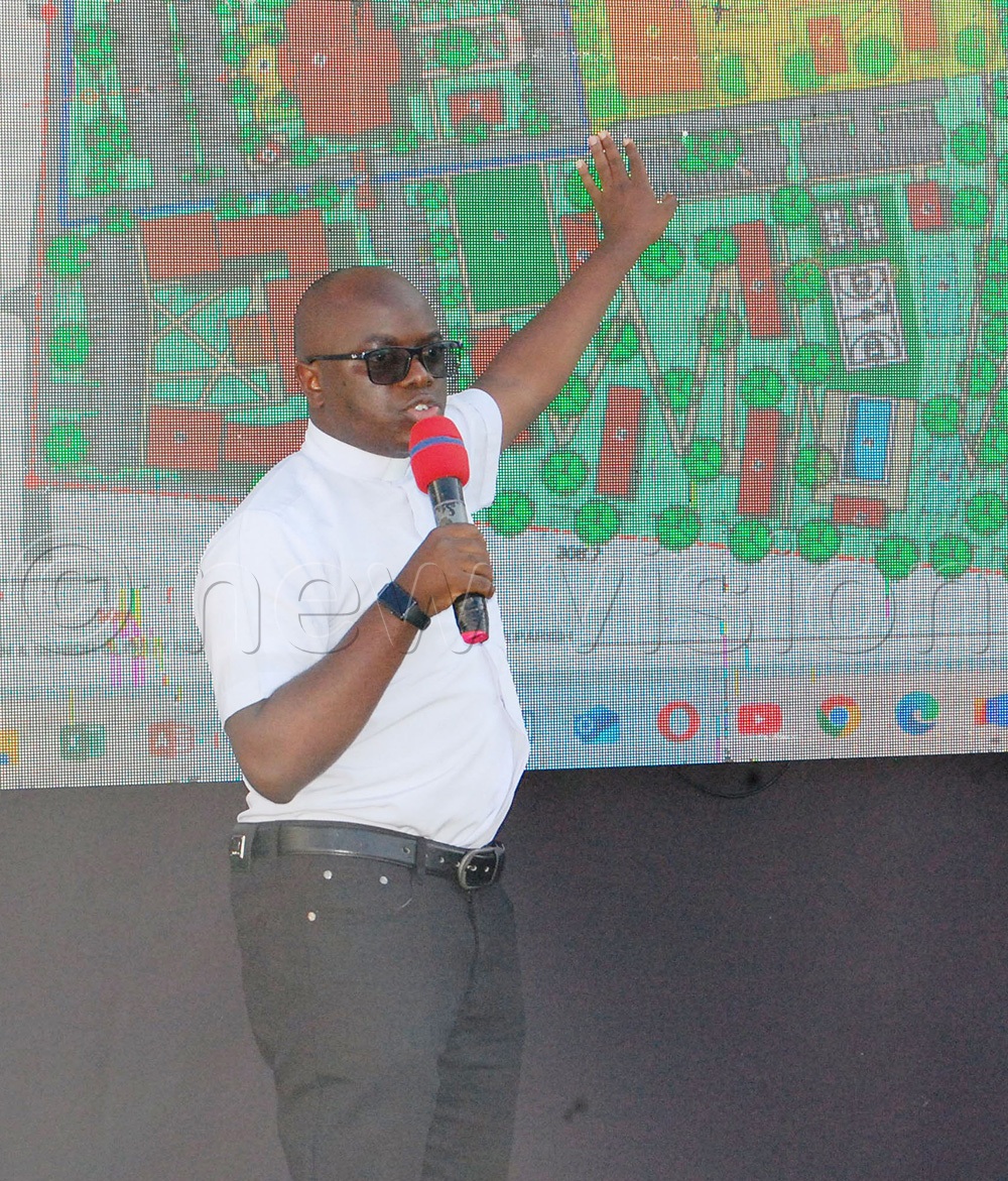 Fr Vianney Ssekalaala (one of the architects) giving an illustration of the project's master plan. (Photo by Mathias Mazinga)