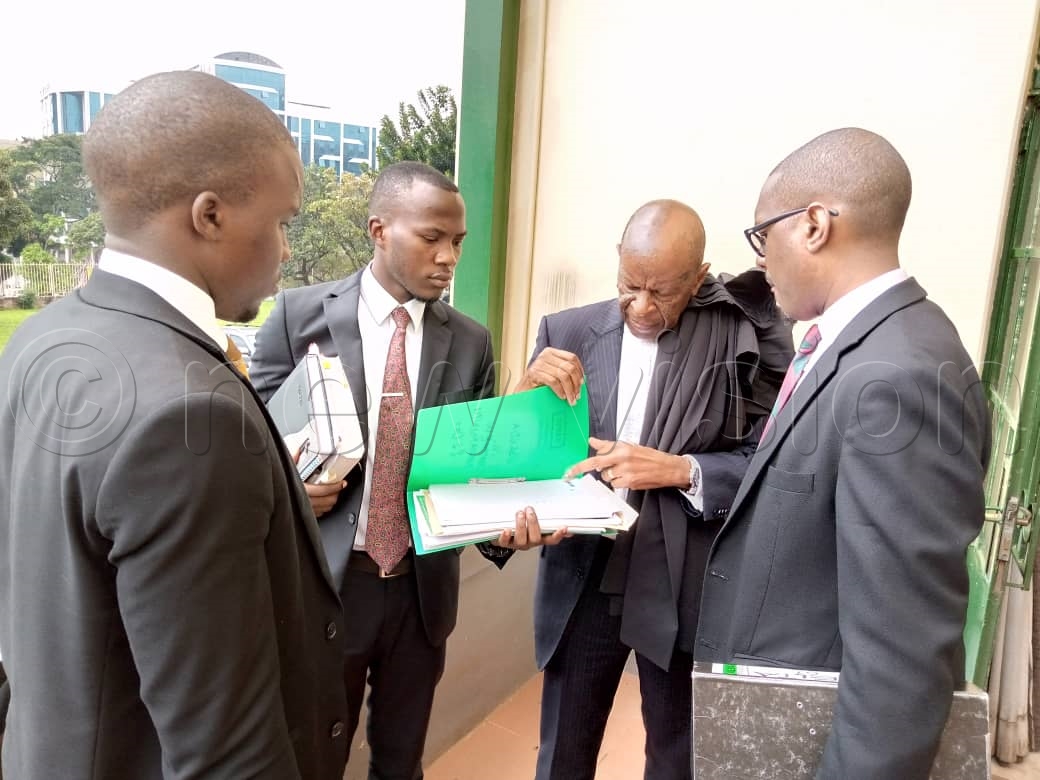 Kanyamunyu (right) with his lawyers