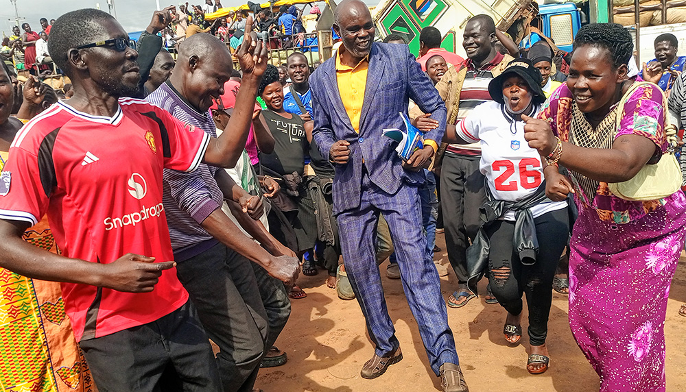 Gulu Main Market Vendor Association chairperson Patrick Omaya dancing with some of his supporters. (Photo by Christopher Nyeko)