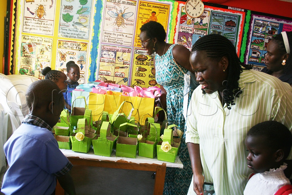 Parents inspect some of the recycled items that were made by the pupils. (Photo by Maureen Nakatudde)