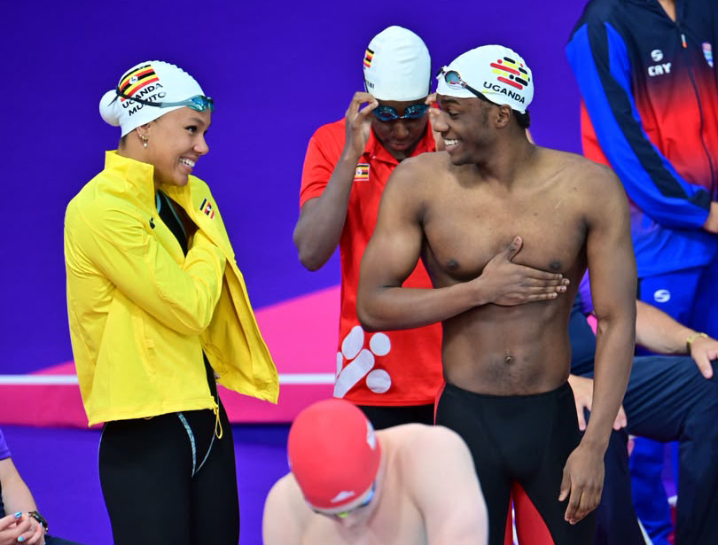Gloria Muzito (left) and Jesse Ssengonzi (right) share a light moment before the 4x100 mixed freestyle relay. 