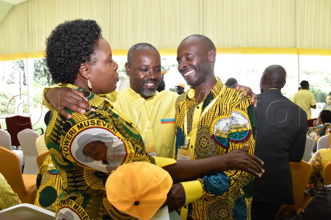 Tayebwa shares a light moment with some of the delegates.