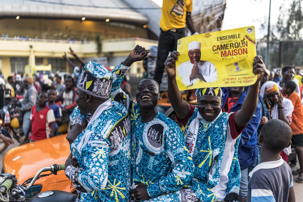 A group of moto taxi drivers, supporting the opposition candidate Issa Tchiroma, parade outside a venue where a concert was organized by the governing party Cameroon People's Democratic Movement (CPDM) of Cameroon incumbent President Paul Biya in Yaounde, on October 11, 2025. (Photo by MARCO LONGARI / AFP)
