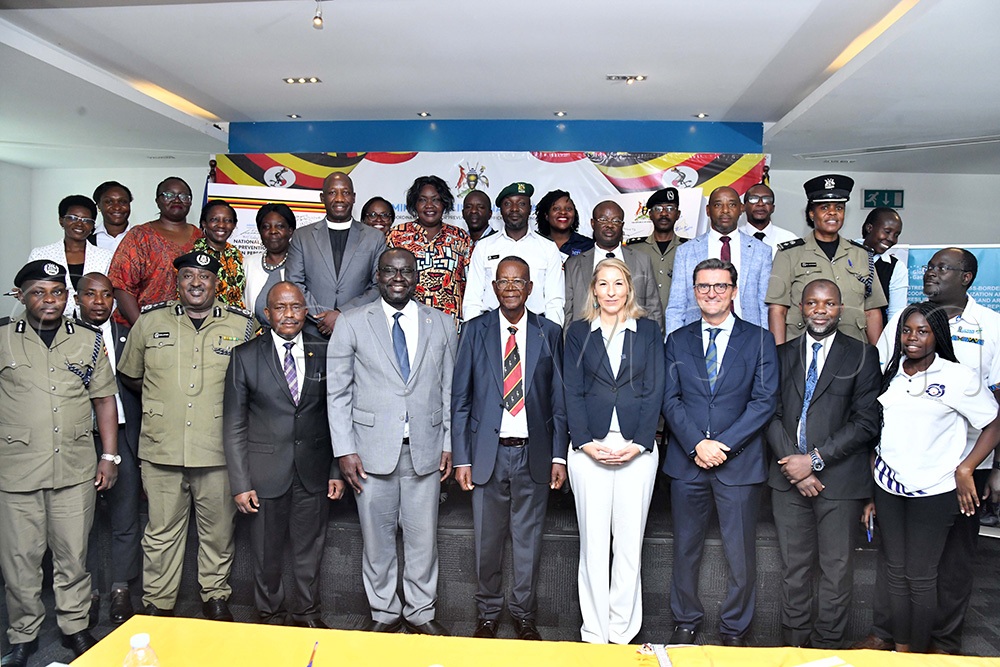 L-R: Moses Taremwa, Commissioner Anti-Human Trafficking Hilary Kulayige, Permanent Secretary Lt. Gen. Joseph Musanyufu, UNDP operations advisor Abdourahmane Dia, Minister of Internal Affairs Prof. Ephraim Kamuntu, Head of Programs and Policy Development IOM Sarah Carl, Alvaro Anton Garcia Head of Finance, Contracts & Audit Section EU and Waiswa Abudu Sallam pose for a photo after the national commemoration event of the world day against trafficking in persons. (Photo by Richard Sanya)