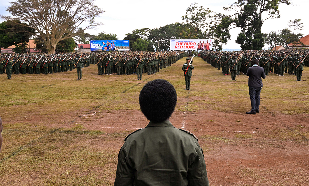 Commissioner Patriotism Helen Seku being welcomed by the parade commander Rahim Ndagire to inspect the parade by patriotism students and teachers of Kings College Buddo during their passout on Saturday. (PPU)