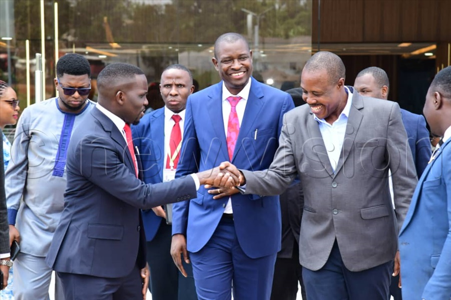 Ssenyonyi (second-left), shakes hands with Wakida (right) as Magoola (second-right) looks on after touring the plant at Kigoogwa, Matugga in Wakiso district. (Credit: Eddie Ssejjoba)