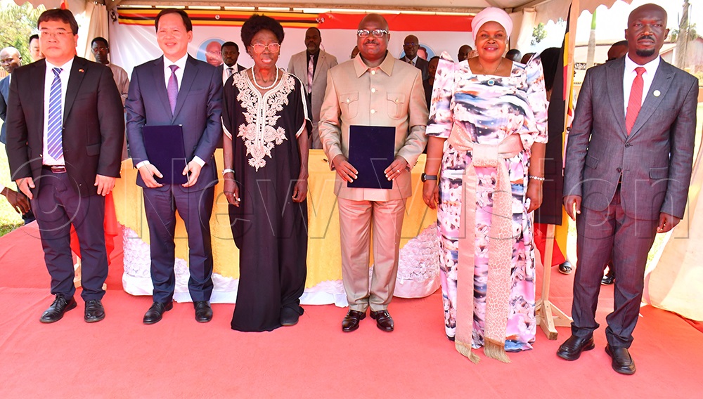 From L-R: Wang Jianxin, the Economic Counsellor at the Chinese Embassy in Uganda, Shandong Province's Vice Chairperson Wen Nuan, First Deputy Prime Minister Rebecca Alitwala Kadaga, BCD's Governor Bishop Frank Tibagendeka, Third Deputy Prime Minister Rukia Nakadama and BCD's Director General Anthony Mula pose for a group photograph after signing an agreement for the establishment of cooperation between BCD and Shandong Province at the Civil Service College of Uganda, Jinja City, on Monday. (Photo by Donald Kiirya)