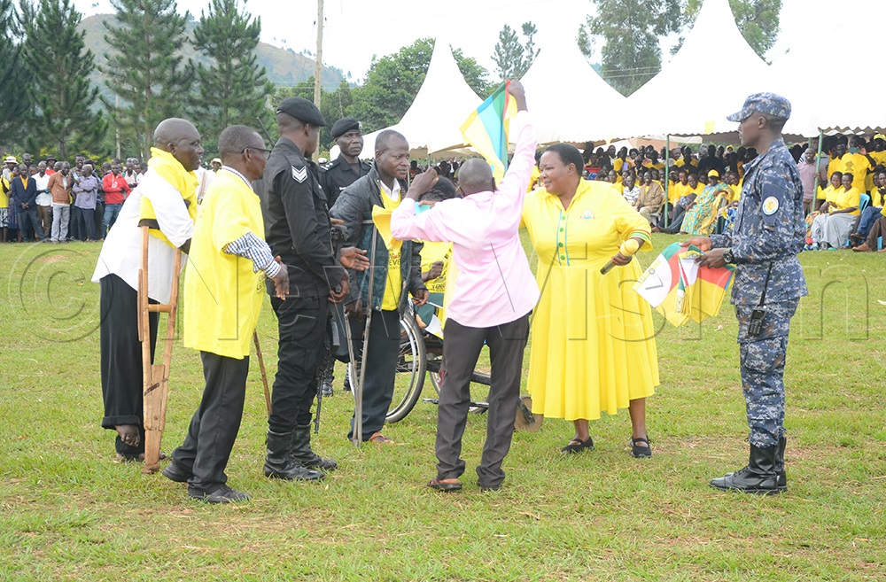 Nabbanja hands out NRM party flags to PWDs flag bearers in Hoima district on Friday. (Credit: Wilson Asiimwe)