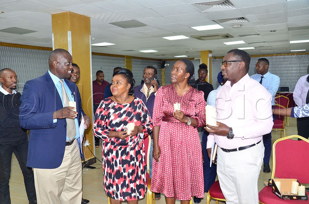 The director of partnerships at UAC, Tom Etti, interacting with renowned artist Joanita Kawalya Stella Namaganda from DOH and William Tibyasa from the Uganda Fish Processors and Exporters Association. (Credit: Agnes Kyotalengerire)