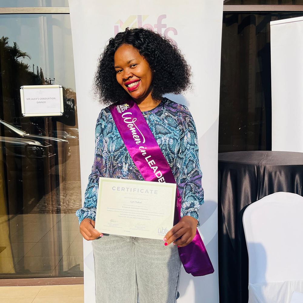 Lyn Tukei, head of public relations and communications at the Capital Markets Authority (CMA) posing for a photo with her certificate. (Courtesy)