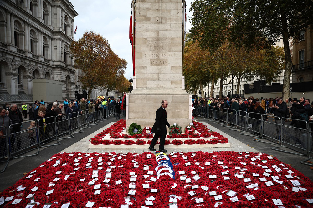People watch as the wreaths are organised at the foot of the Cenotaph on Whitehall in London on November 9, 2025 following the Remembrance Sunday ceremony.