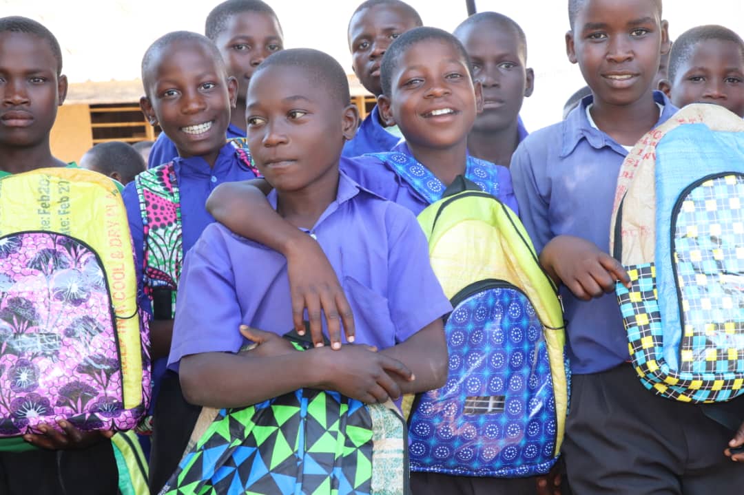 Bonga boys from Walibo Primary School in Luuka District pose for a photo after receiving ECOJUA solar-powered school bags, part of a campaign by Stromme Foundation to keep children in school.