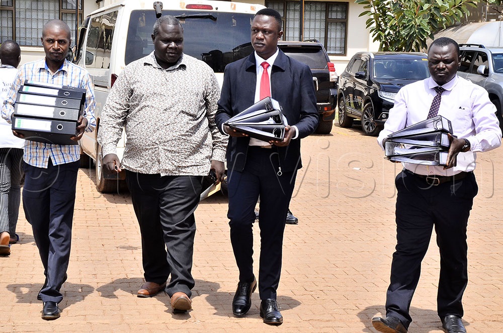 The National Peasant Party members followed by the Secretary General of National Peasant Party, Sharif Ssentongo (second left) arrive with files containing signatures during the submission of signatures for nomination at the Electoral Commission office in Kampala on 15 September 2025. (Photo by Ronnie Kijjambu)