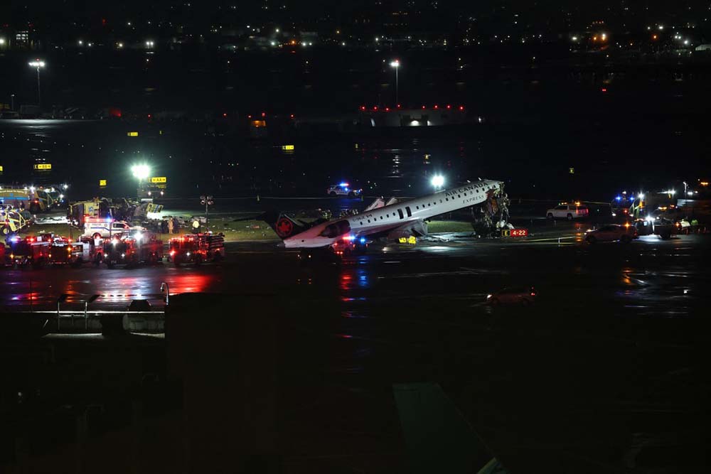 An Air Canada Express CRJ-900 sits on the runway after colliding with a Port Authority fire truck at LaGuardia Airport in New York, on March 23, 2026. Air Canada Express flight AC8646 originated from Montreal and collided with the fire truck during landing. (Credit: AFP)