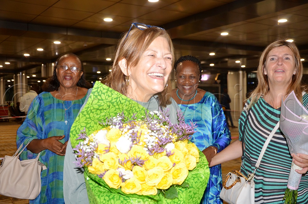 President General of WUCWO Mónica Santamarina holds her flowers after being welcomed by the team in Uganda on her arrival at Entebbe International Airport on Monday morning July 28, 2025. (Photo by Juliet Anna Lukwago)