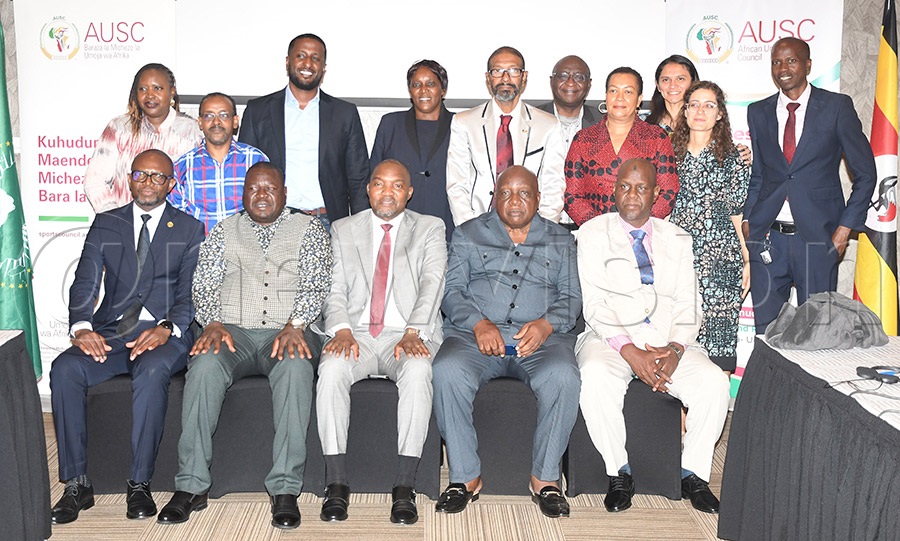 Outgoing advisory board chairman Patrick Ogwel (seated-2nd left), incoming chairman Júlio Ambali Mendes (center), Chipande (left), Zenon Kasongo Kabamba (2nd righ) and Abbas Bah (right) pose with the other bureau members at Mestil Hotel. Photo by Michael Nsubuga