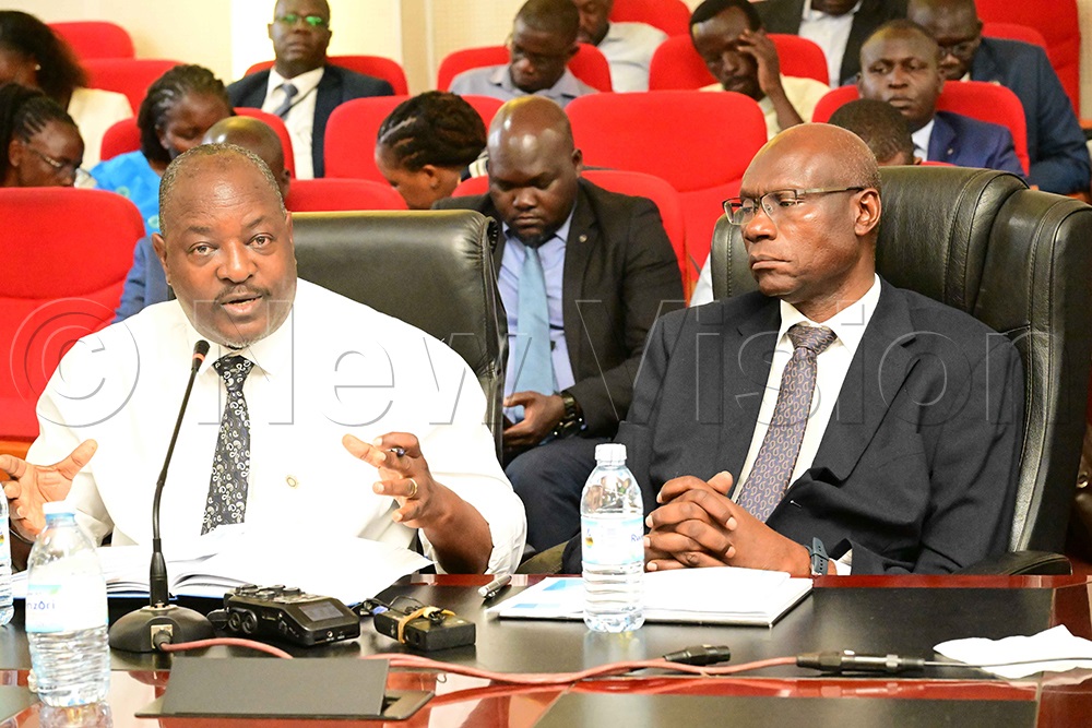 Lammeck Kajubi of Queensland and Leeds Consulting Engineers gives an update on air quality in the Kampala Metropolitan Area during the launch of the 3rd Annual Performance Assessment Results for the 2024/2025 financial year for nine entities in the Kampala Metropolitan Area at the Ministry of Finance on August 12, 2026. Right is Stephen Ajalu, a Senior Urban Development Specialist. (Photo by Eddie Ssejjoba)