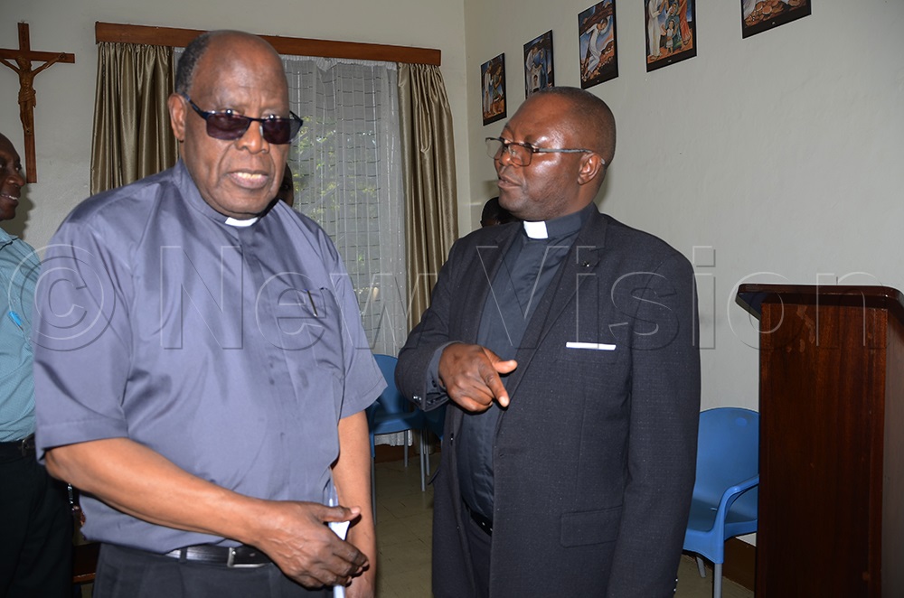 The Diocese chairperson of the organising committee, Fr John Baptist Kule (right), chats with Secretariat General of the Episcopal conference, Msgr John Baptist Kauta (Left) after the National preparation meeting Catholic Secretariat Nsambya on Thursday. (Photo by Juliet Anna Lukwago) 