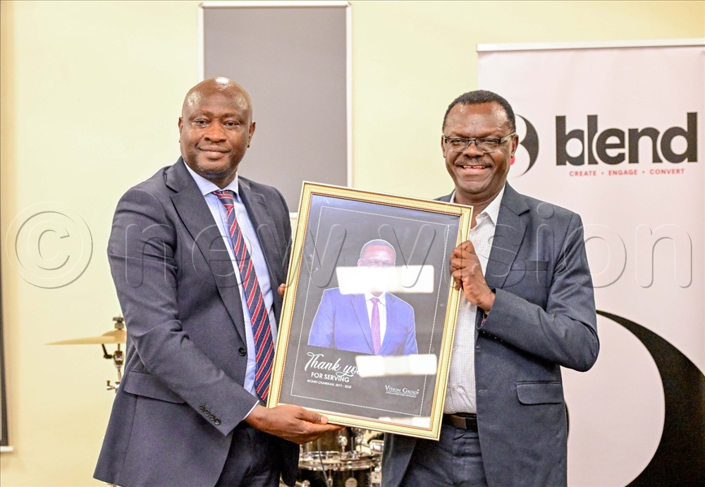Vision Group board chairperson Dr Edward Damulira Sengonzi(left) with outgoing chairperson Patrick Ayota.