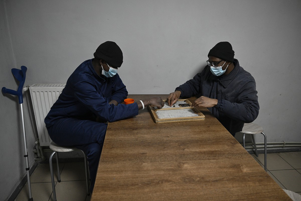  Nationals of African countries sit in a dedicated section where foreign fighters captured while serving for Russian forces on the Ukrainian front are hold at a detention center for Russian POWs in western Ukraine on November 26, 2025, amid the Russian invasion of Ukraine. (Photo by Genya SAVILOV / AFP)