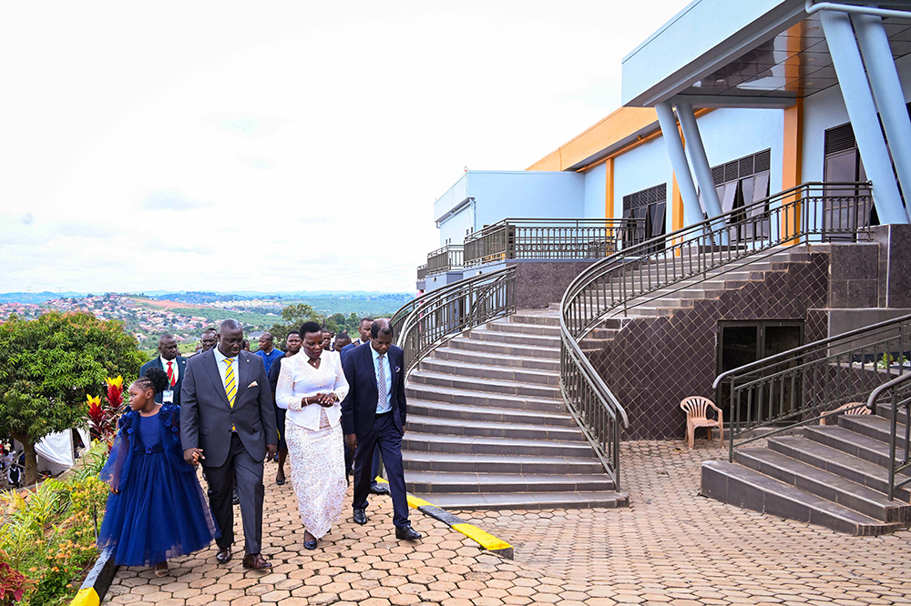 Pastor Kenneth Kato (L) taking Hon. Beatrice Akello the State Minister for Economic Monitoring and Pastor Robert Kayanja (R) on a guided tour of Life Restoration Ministries church during its commissioning. (PPU)