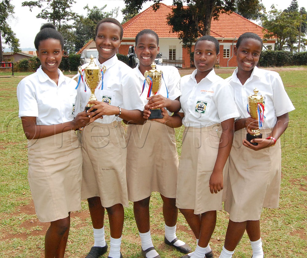 Students from Immaculate Heart Girls School Nyakibale enjoying a photo moment with their trophies. (Photo by Mathias Mazinga)