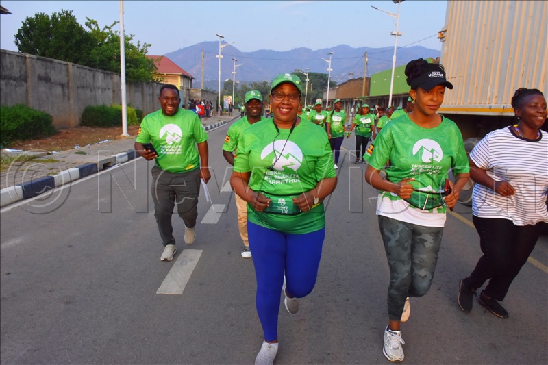 Doreen Katusiime (right), the Permanent Secretary for the Ministry of Tourism, Wildlife and Antiquities, racing 5km.