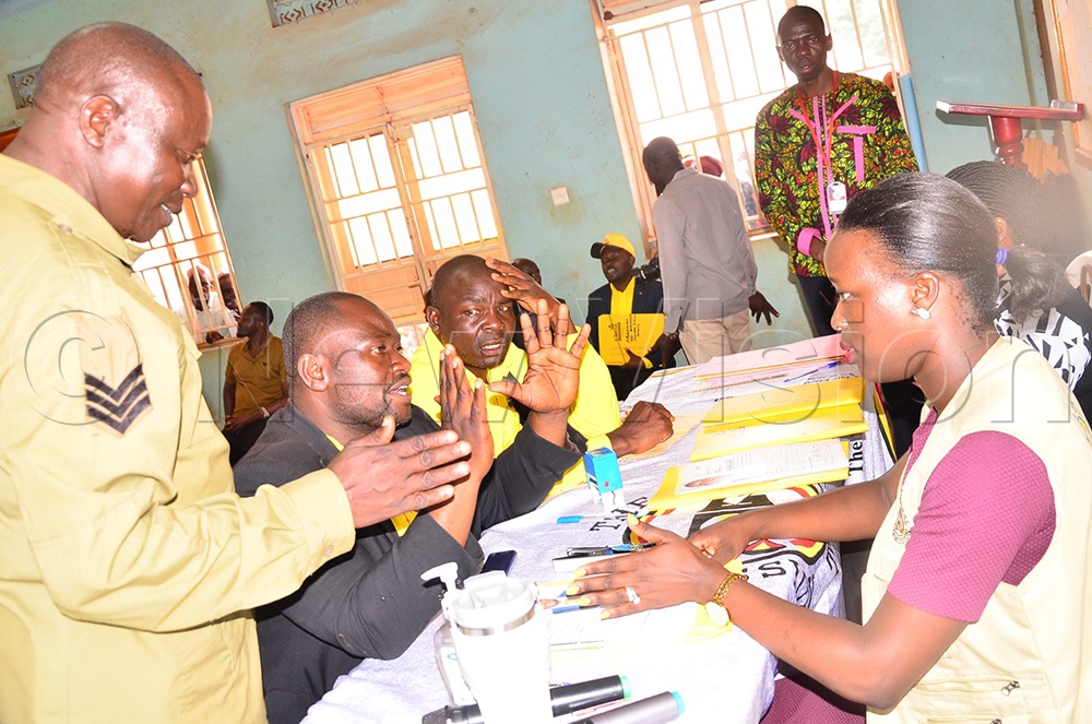 Nasasira listening to Mudoola (in black) flanked by Mubale as he resisted to be thrown out and requested for a halt of their nomination until guidance from the party headquarters. (Photo by Jackie Nambogga)