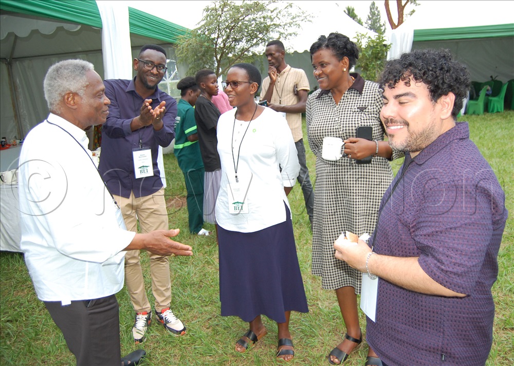 Cardinal Peter Turkson (lleft) shares a light moment with some of the conference participants during a tea-break.