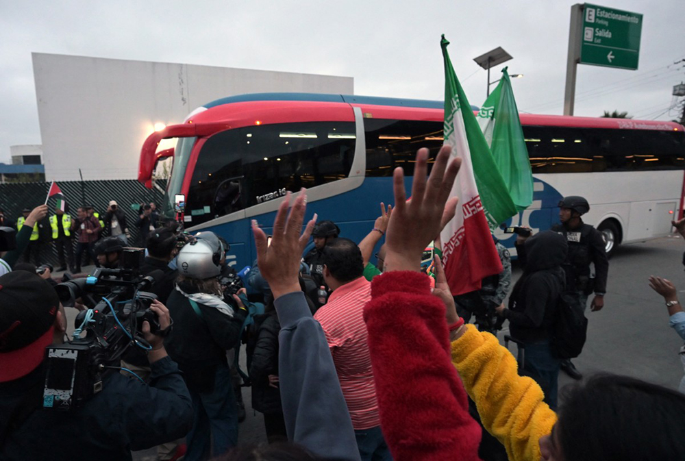 Football fans cheer as Iran's players leave the Tijuana International Airport on a bus in Tijuana, Mexico on June 7, 2026, ahead of the FIFA 2026 World Cup football tournament. (AFP)